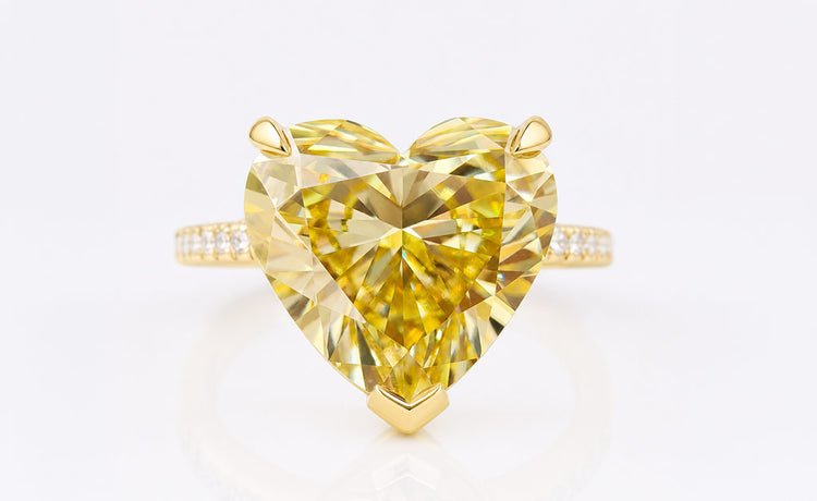 Heart cut coloured moissanite ring with a tinted centre stone in solid gold