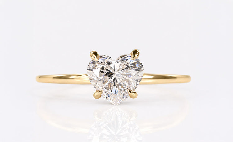 Heart cut lab grown diamond solitaire ring on a plain solid gold band