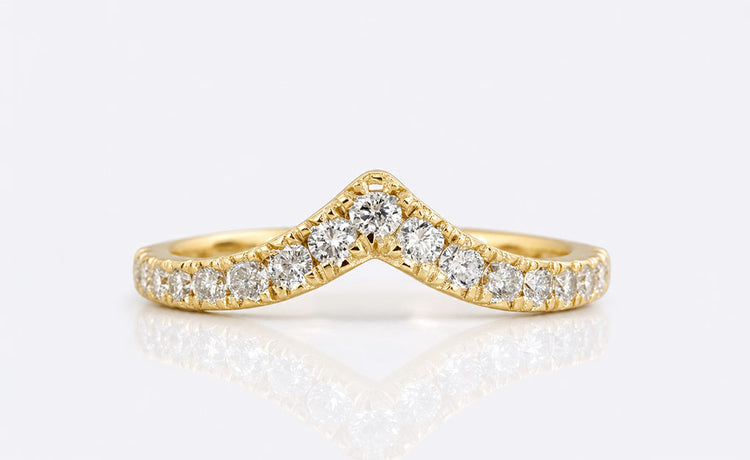 Curved lab grown diamond wedding band shaped to sit flush against an engagement ring