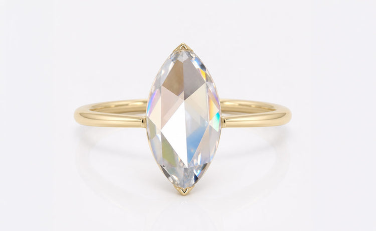 Marquise cut coloured moissanite ring with a tinted centre stone in solid gold