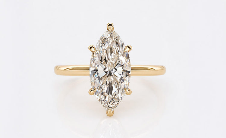 Marquise cut lab grown diamond solitaire ring on a plain solid gold band