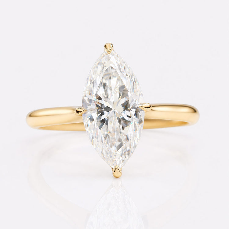 Marquise cut moissanite solitaire ring on a plain solid gold band