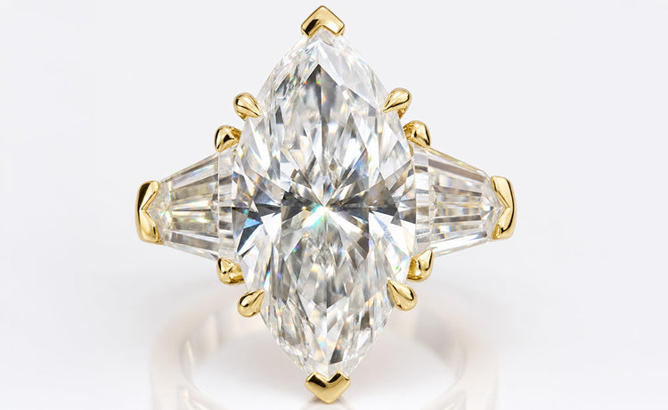 Marquise cut moissanite three stone ring with a centre stone and two side stones