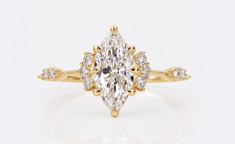 Marquise cut engagement ring with an elongated pointed centre stone in a gold band