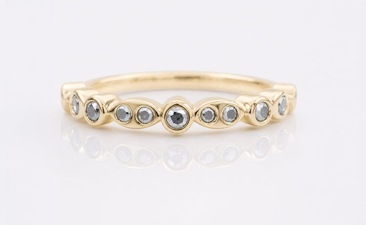 Moissanite half eternity band with stones set across the front half of the ring