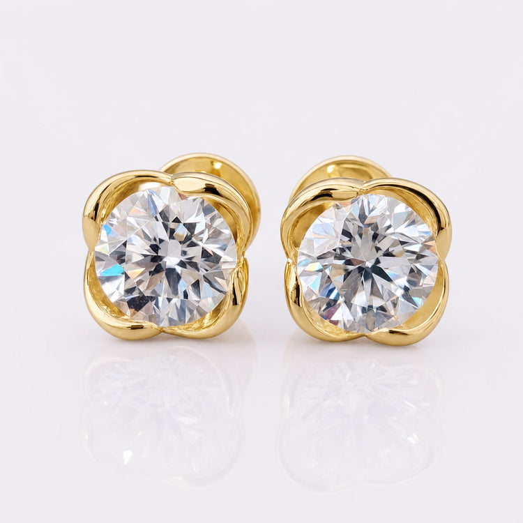 Round brilliant cut moissanite stud earrings in four prong solid gold settings