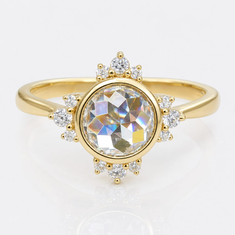Vintage style moissanite engagement ring with milgrain detailing and an ornate gold setting