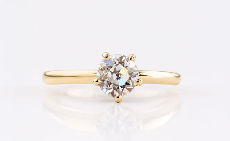 Old European cut moissanite solitaire ring on a plain solid gold band