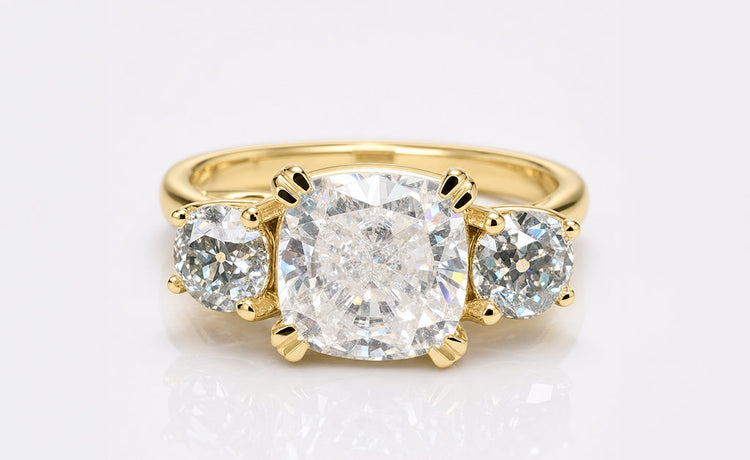 Old European cut moissanite three stone ring with a centre stone and two side stones
