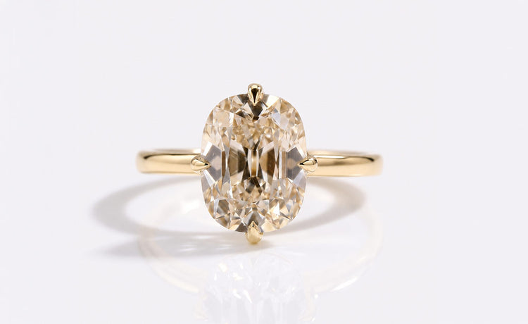 Old mine cut moissanite ring with a cushion outline and antique faceting