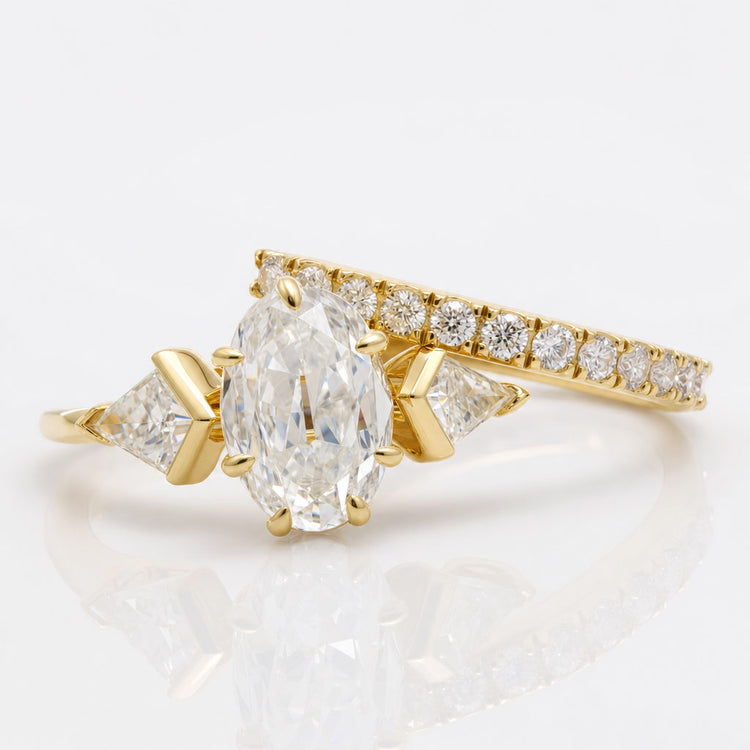 Oval cut moissanite bridal set with a matching engagement ring and wedding band