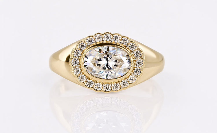 Oval cut moissanite halo ring framed by pave set stones