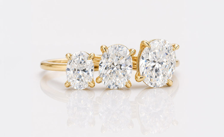 Oval cut moissanite solitaire ring on a plain solid gold band