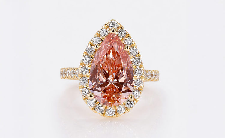 Pear cut coloured lab grown diamond ring with a tinted centre stone
