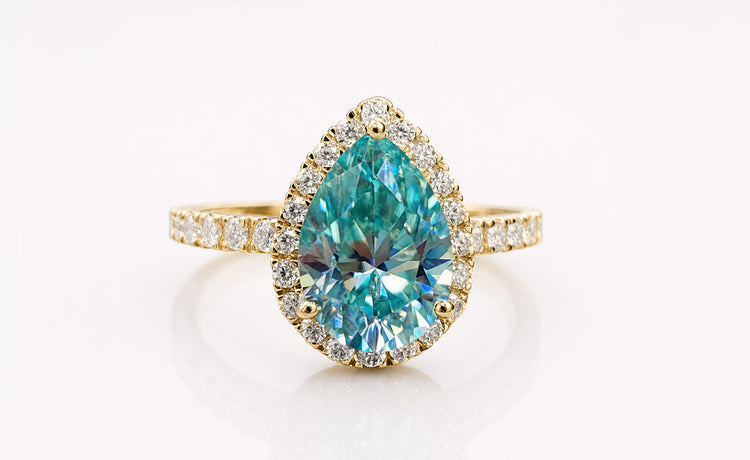 Pear cut coloured moissanite ring with a tinted centre stone in solid gold