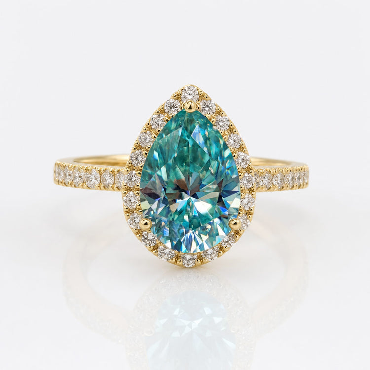 Pear cut moissanite halo ring framed by pave set stones