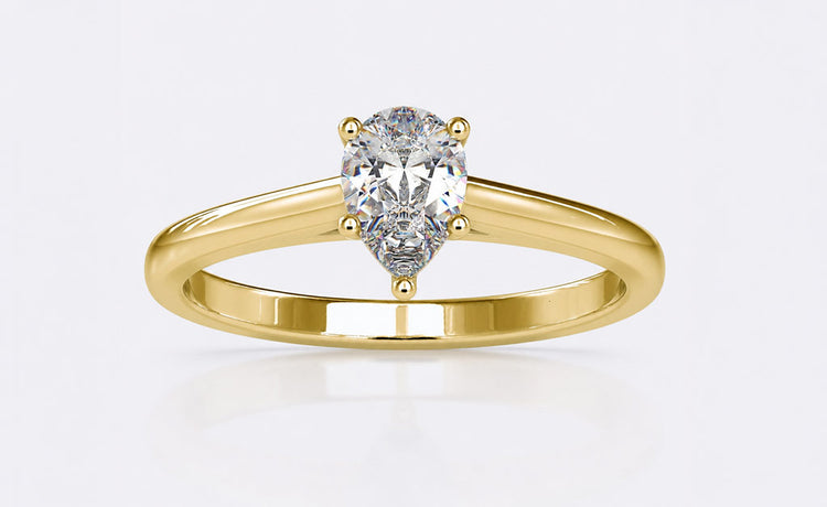 Pear cut moissanite engagement ring with a teardrop centre stone in gold