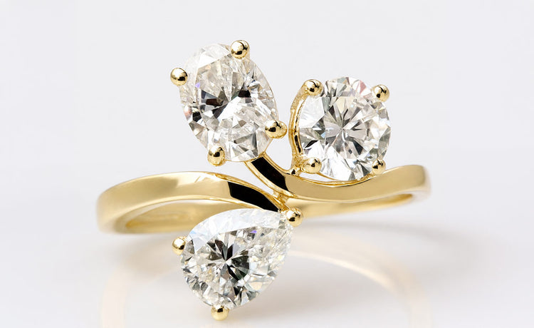 Pear cut moissanite three stone ring with a centre stone and two side stones