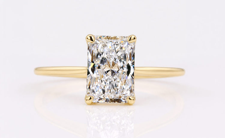 Radiant cut lab grown diamond solitaire ring on a plain solid gold band