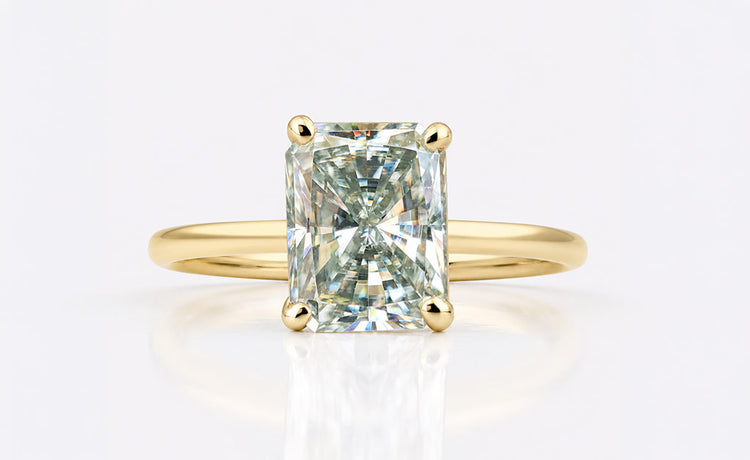Radiant cut moissanite solitaire ring on a plain solid gold band