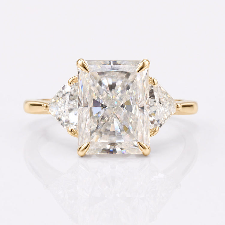 Radiant cut moissanite three stone ring with a centre stone and two side stones
