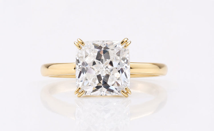 Rensu cut moissanite solitaire ring on a plain solid gold band