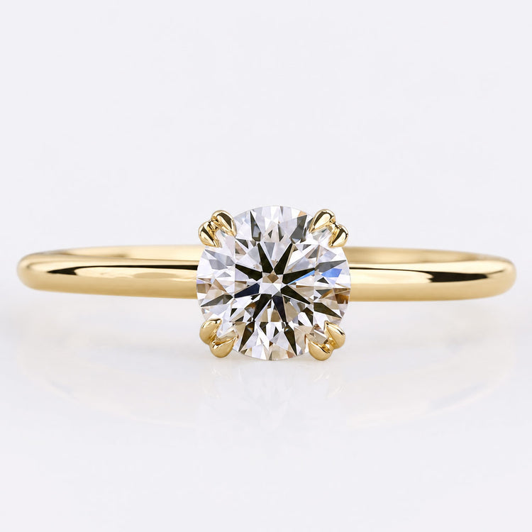 Round cut lab grown diamond solitaire ring on a plain solid gold band