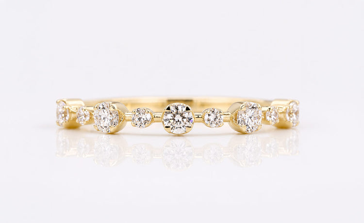 Stackable rings in solid gold worn together with moissanite and diamond accents