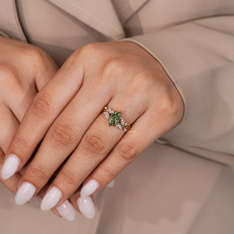 Marquise diamond ring with six prongs and side stones.