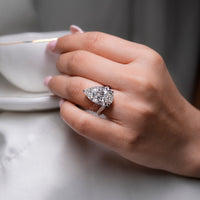 Double row pave engagement ring with pear lab grown diamond.