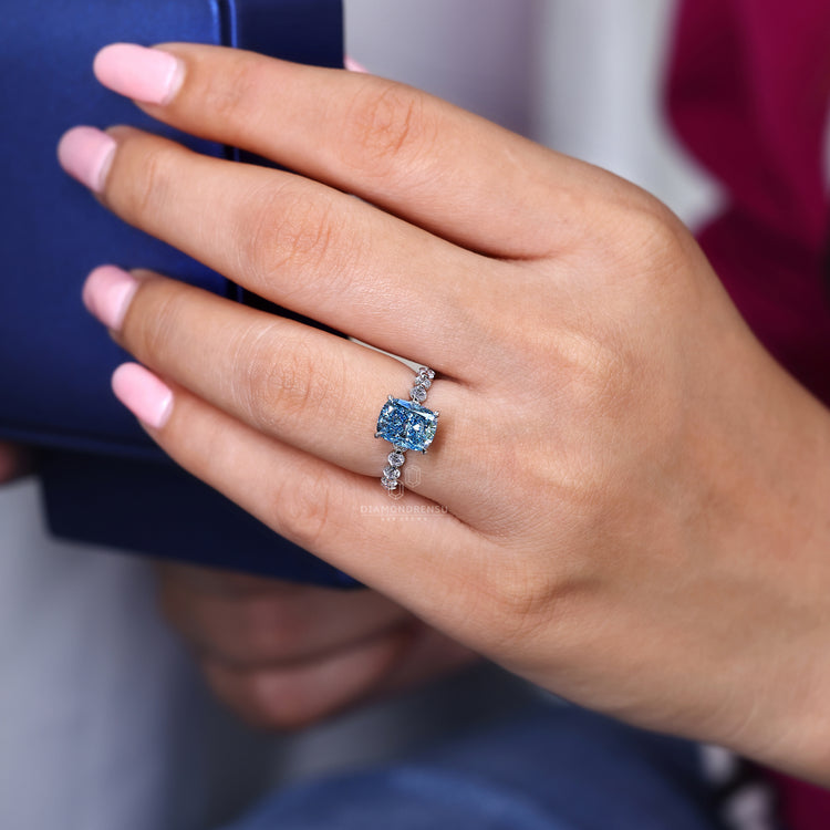 Lab grown cushion cut diamond ring in shared prong setting.
