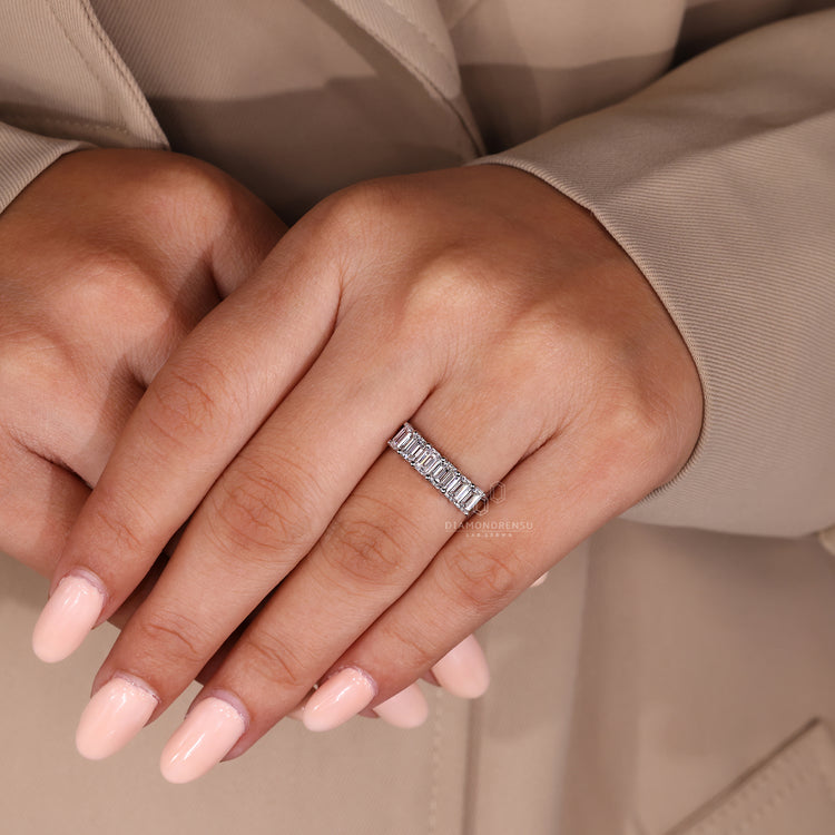 Handmade emerald cut diamond wedding band shared prong.
