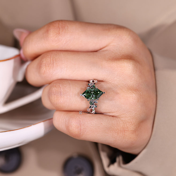Green diamond ring featuring marquise and round moss agates.