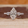 Dutch marquise ring with pear cut side stones in three stone style.
