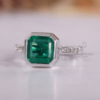 Handmade Asscher cut emerald ring bezel setting style.
