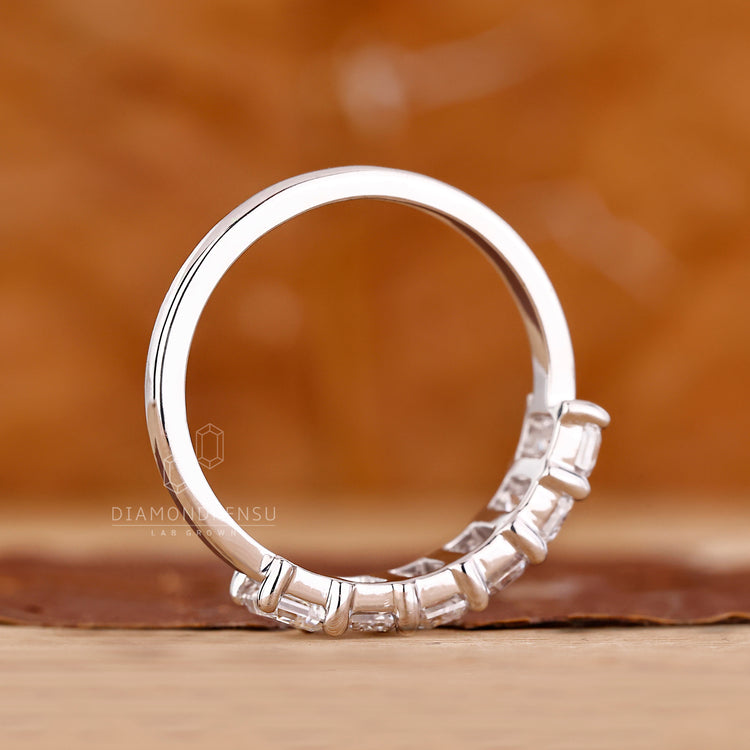 IGI certified emerald cut diamond band six stone style.
