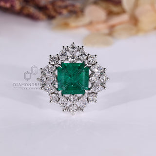Asscher emerald ring marquise stones cluster twisted shank.
