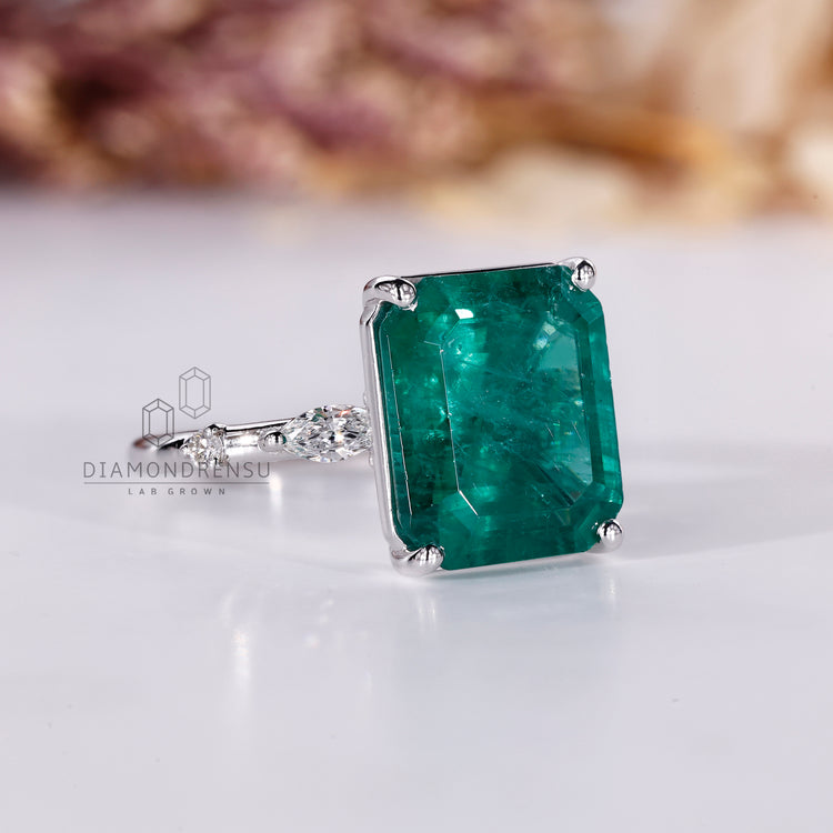 Emerald gemstone ring round marquise pave prong set.
