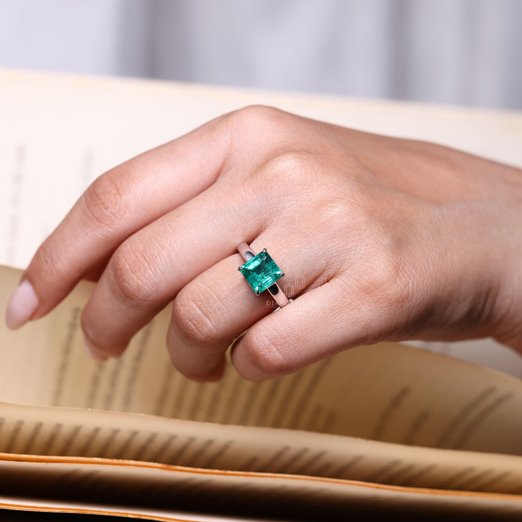 Emerald gemstone ring Asscher cut solitaire prong set.
