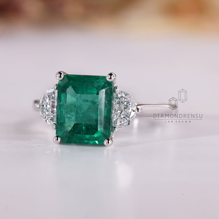 Handmade emerald cut ring half moon three stone design.
