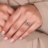 Emerald old European cut ring with leaf style prong.
