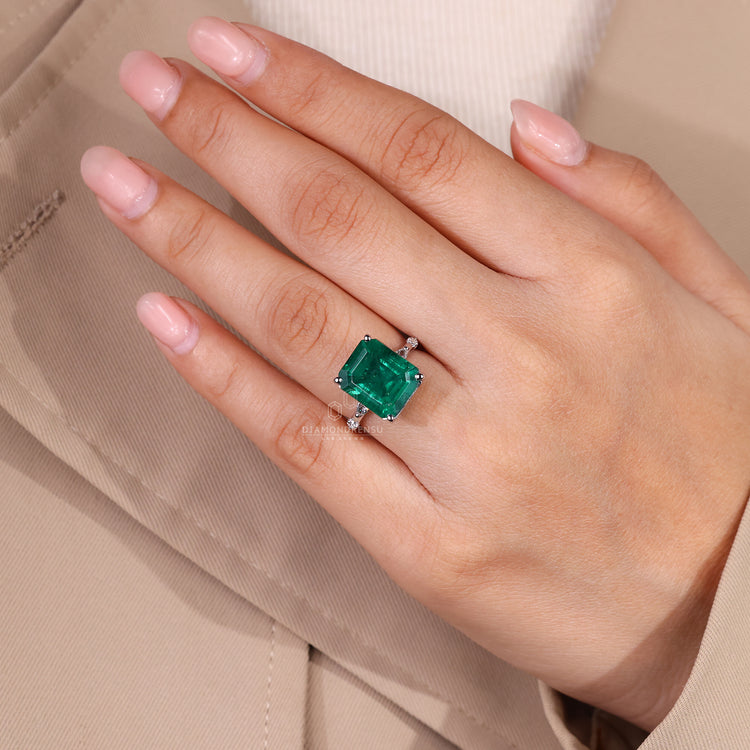 Emerald cut emerald ring marquise round pave design.
