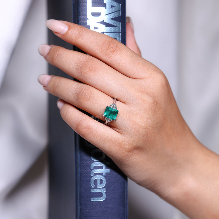 Emerald cut ring three stone tapered shank prong set.
