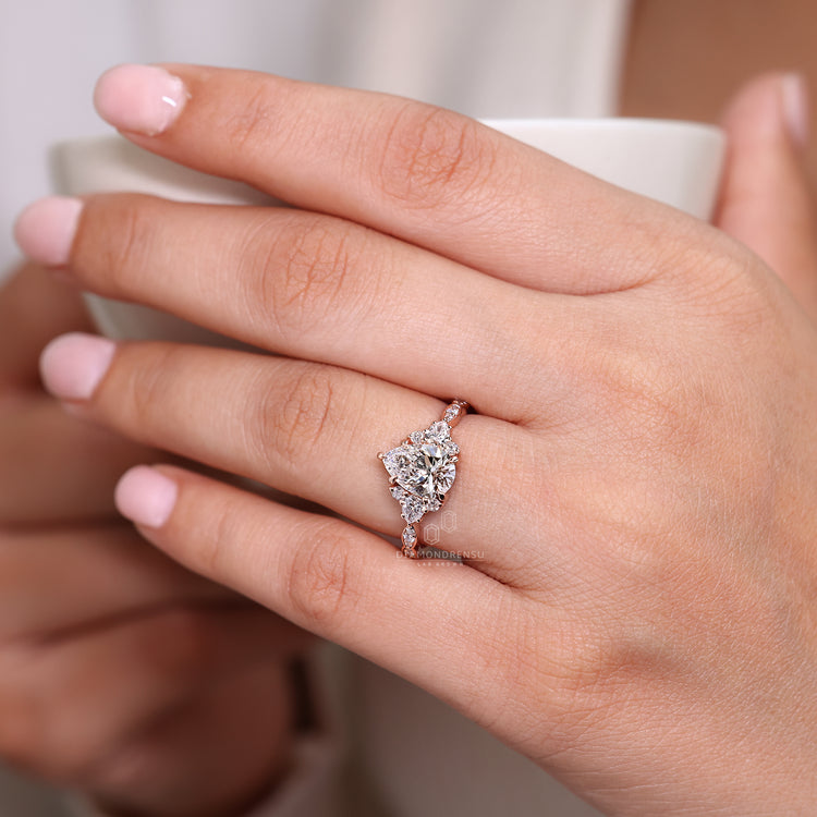 Pear cut ring cluster muse marquise pave setting.