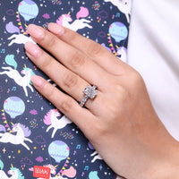 Lab grown radiant diamond ring with four claw prongs.
