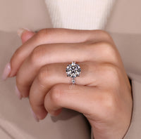 Lab grown blue oval diamond ring with heart accents.
