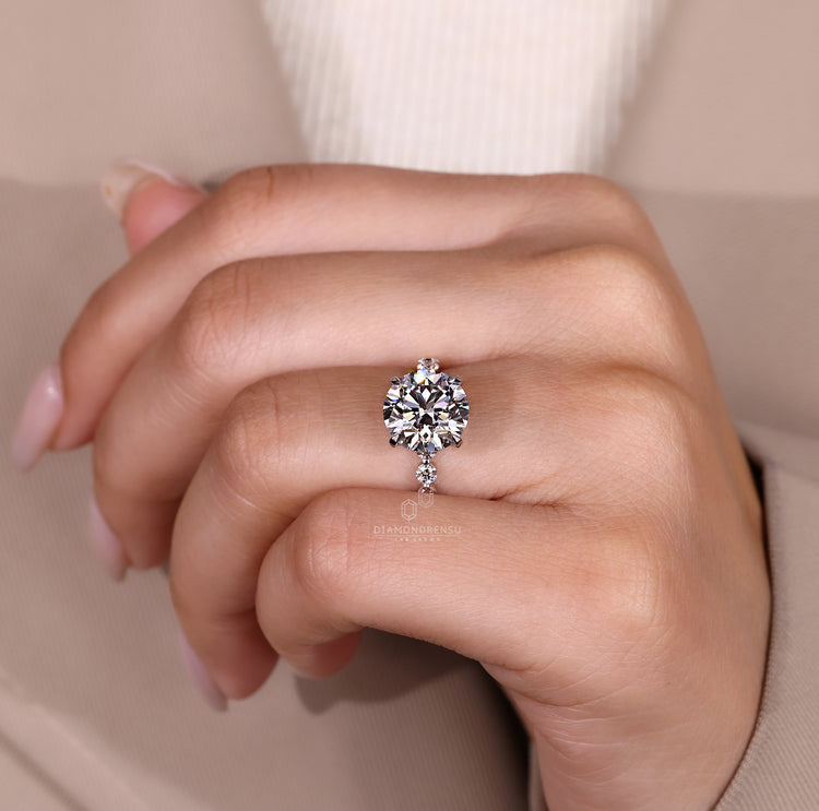 Lab grown blue oval diamond ring with heart accents.
