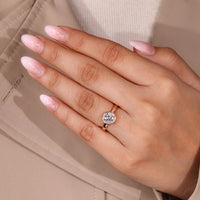 Round diamond ring four claw prong halo bezel set.

