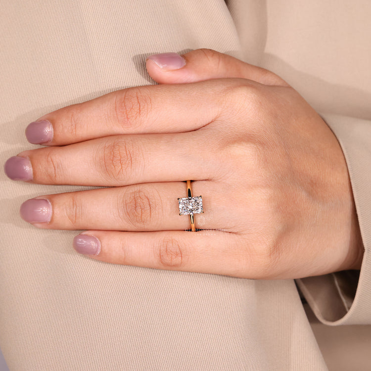 Radiant cut diamond ring with four claw prong setting.