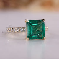 Emerald gemstone ring Asscher cut pave prong style.
